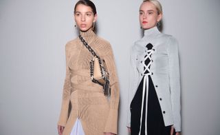 Two female models, one wearing a tan-coloured dress with bag, and the other wearing a white coat over a black outfit