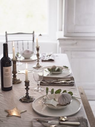 Simple white tablescape with antique candlesticks