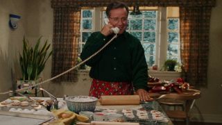 Phil Hartman takes a call in front of a bunch of cookies in Jingle All The Way.