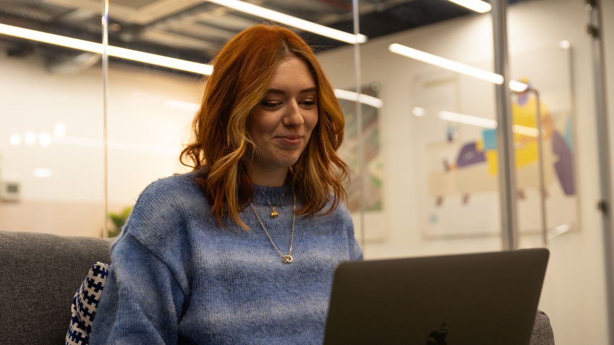 woman with red hair at a laptop