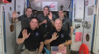 NASA astronauts Bob Behnken (bottom left) and Doug Hurley (bottom right), the crew of SpaceX's Demo-2 Crew Dragon mission, say farewell to their Expedition 63 crewmates - NASA's Chris Cassidy (top center) and Roscosmos' Ivan Vagner (top left) and Anatoly Ivanishin during a farewell ceremony on the International Space Station Aug. 1, 2020.