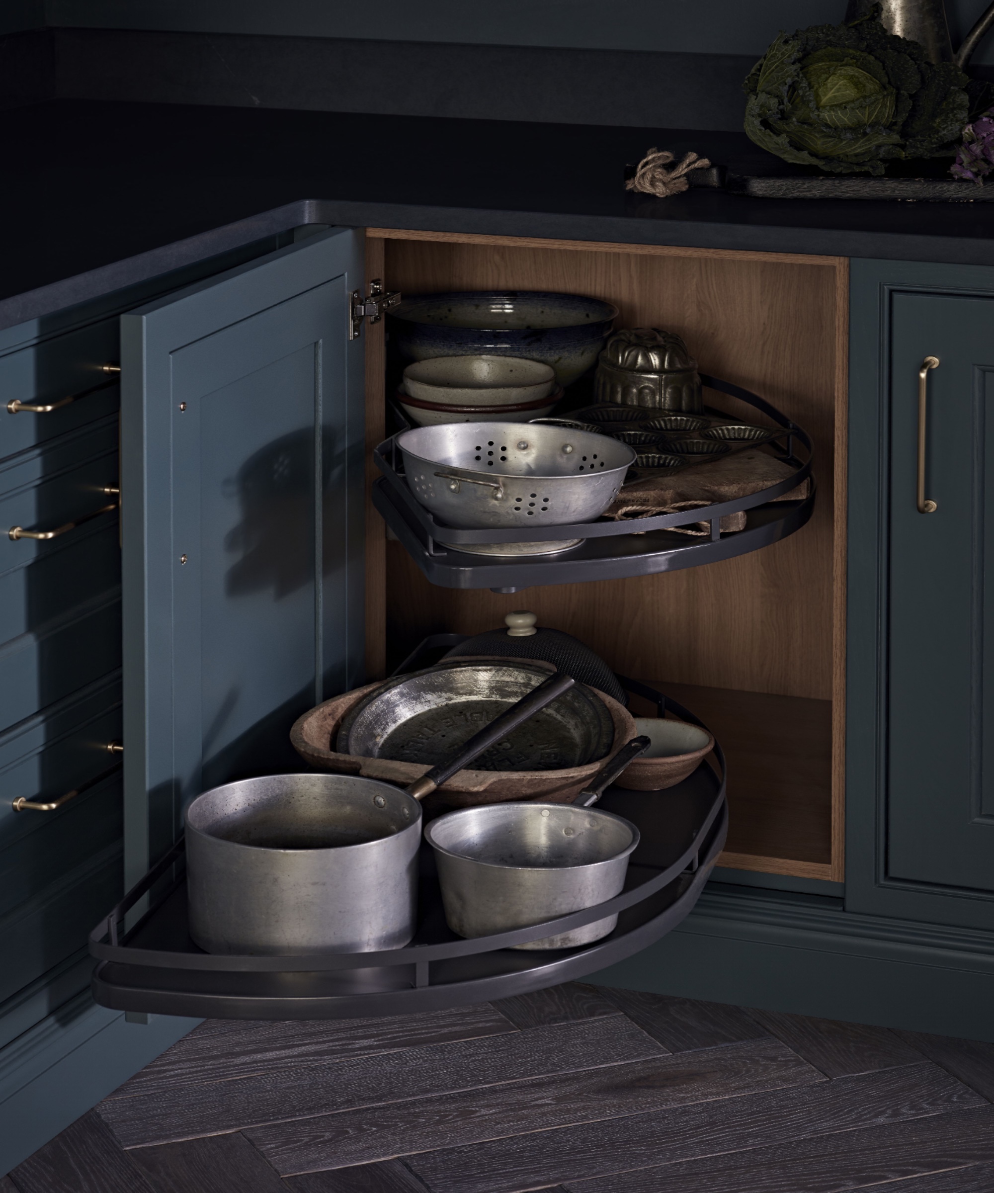 Pots and pans in movable shelves in cupboard