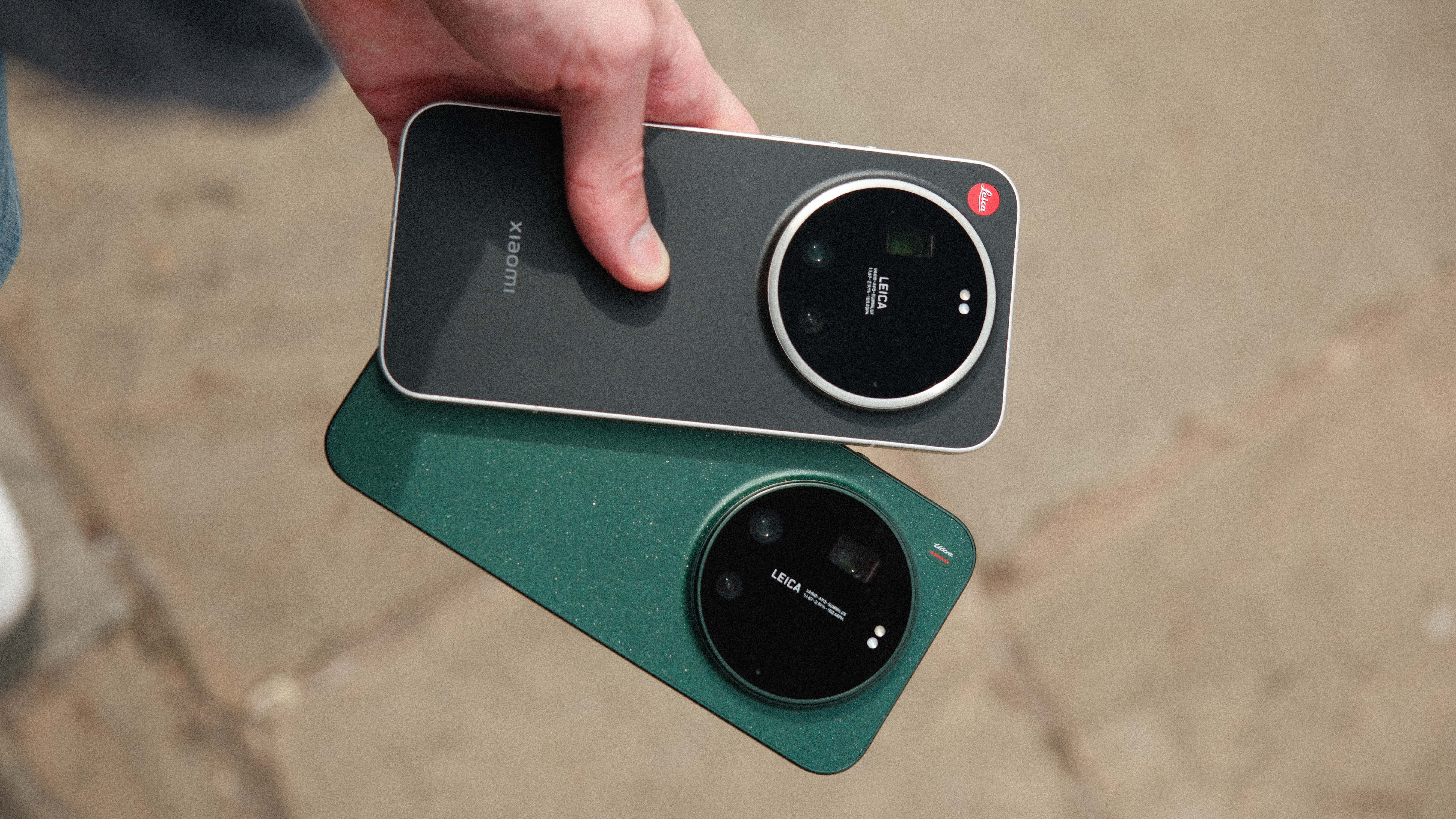 Hand holding the Leica Leitz Phone above a green Xiaomi phone