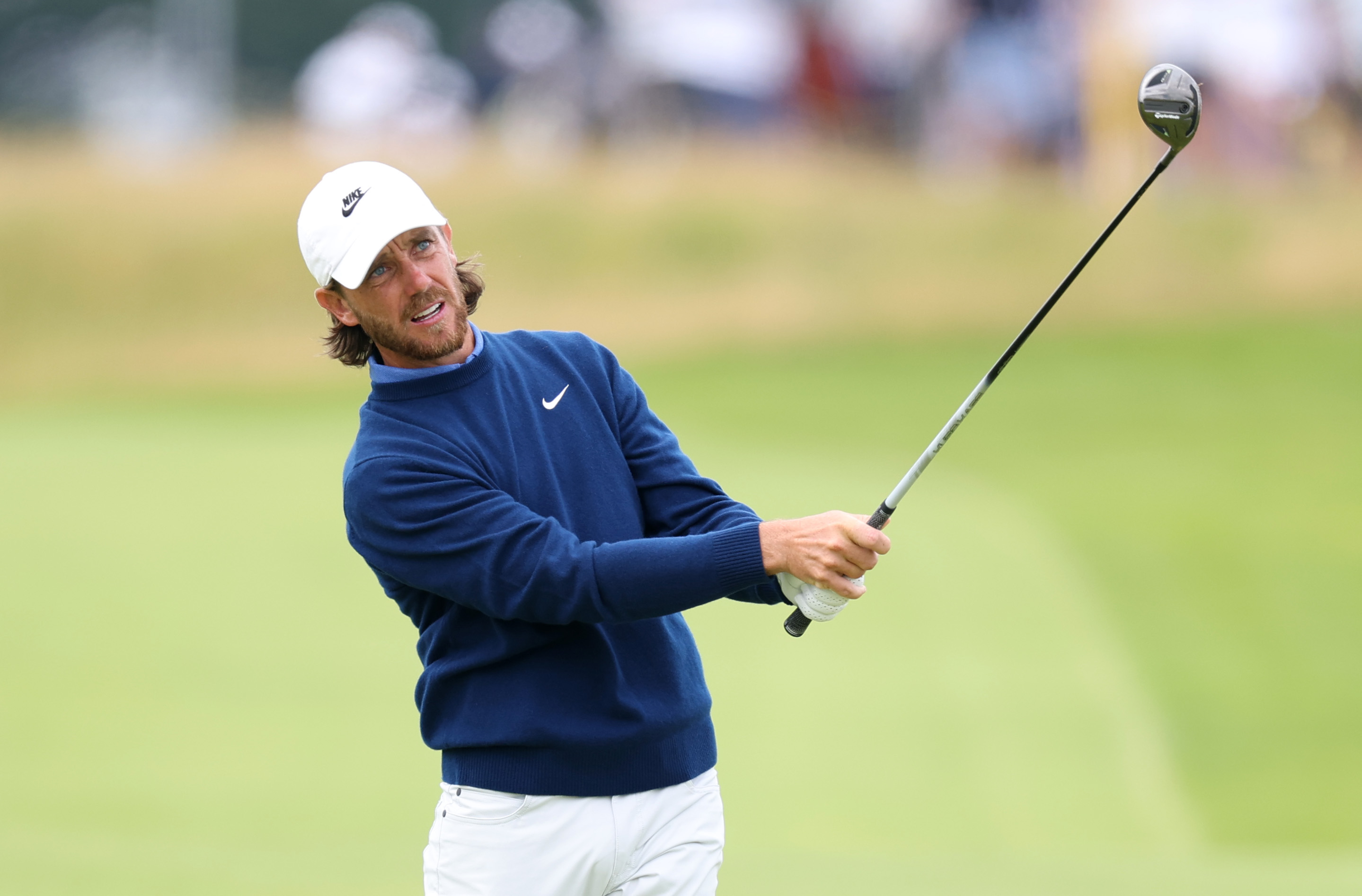 Tommy Fleetwood hits a fairway wood