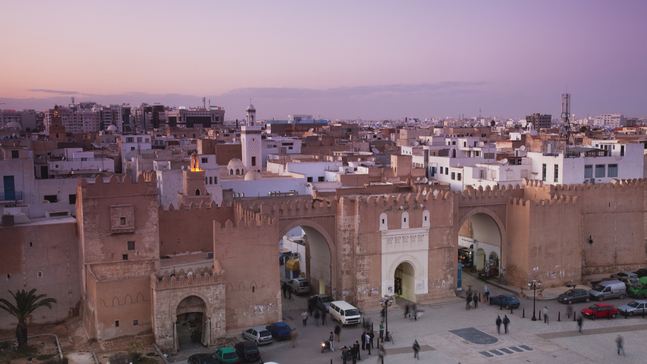 a low rise city with old walls surrounding the scene.