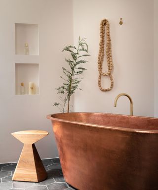 bathroom with white walls and copper tub