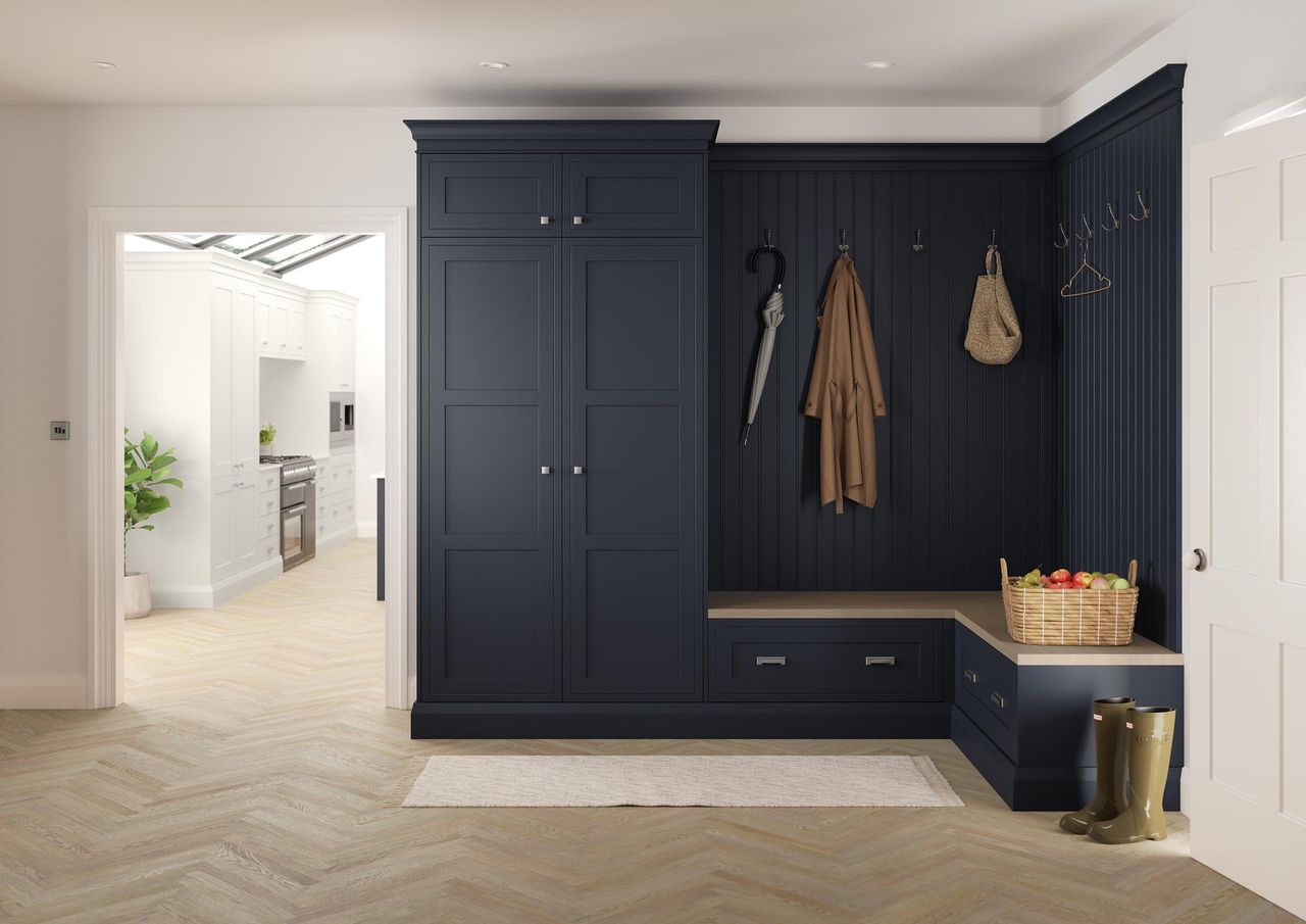 A mudroom cabinet painted a dark blue/grey