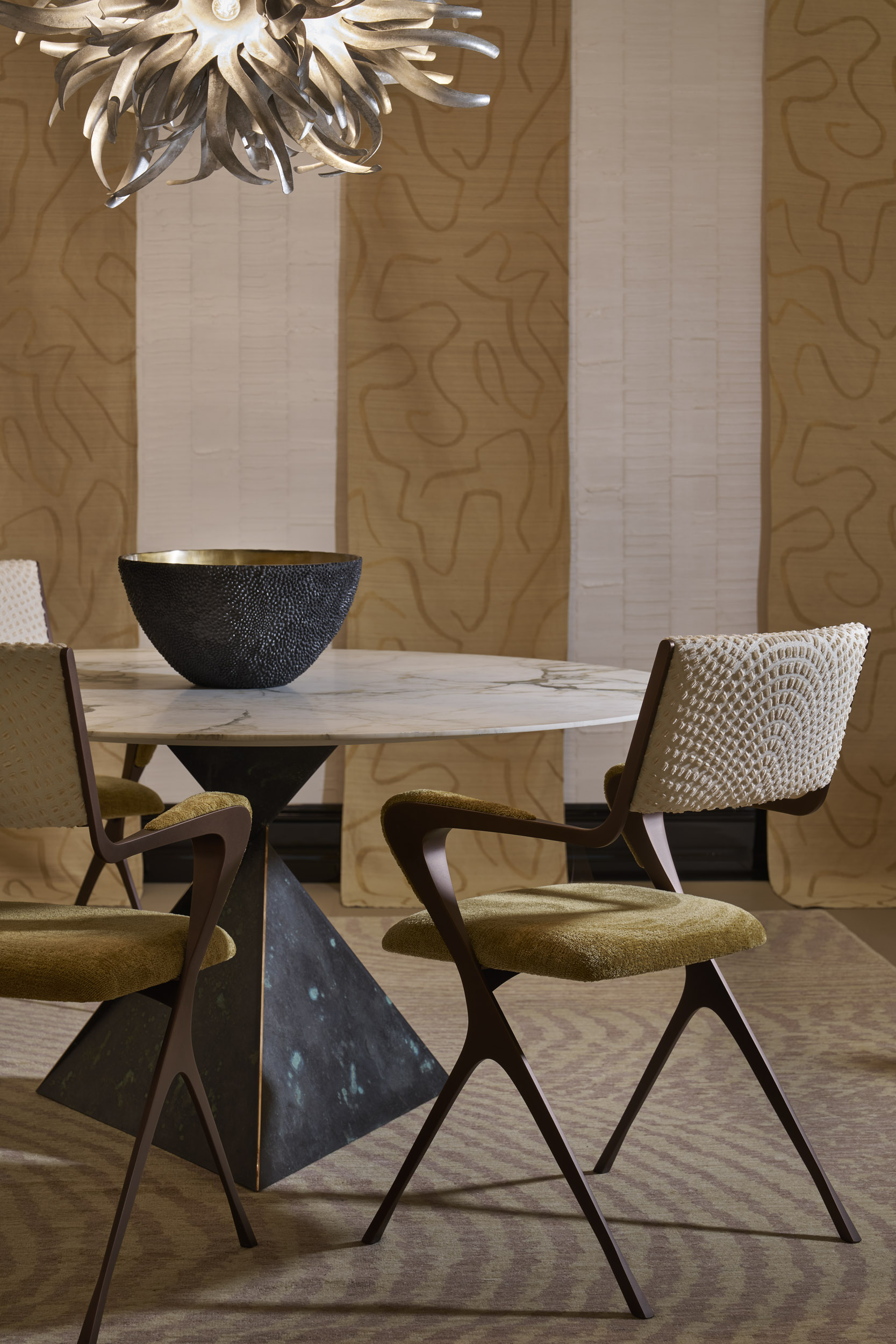 A series of interior shots of beautifully furnished spaces with a blue, white, and gold palette and plenty of textural elements like artworks, handcrafted accessories, and pendant lighting.