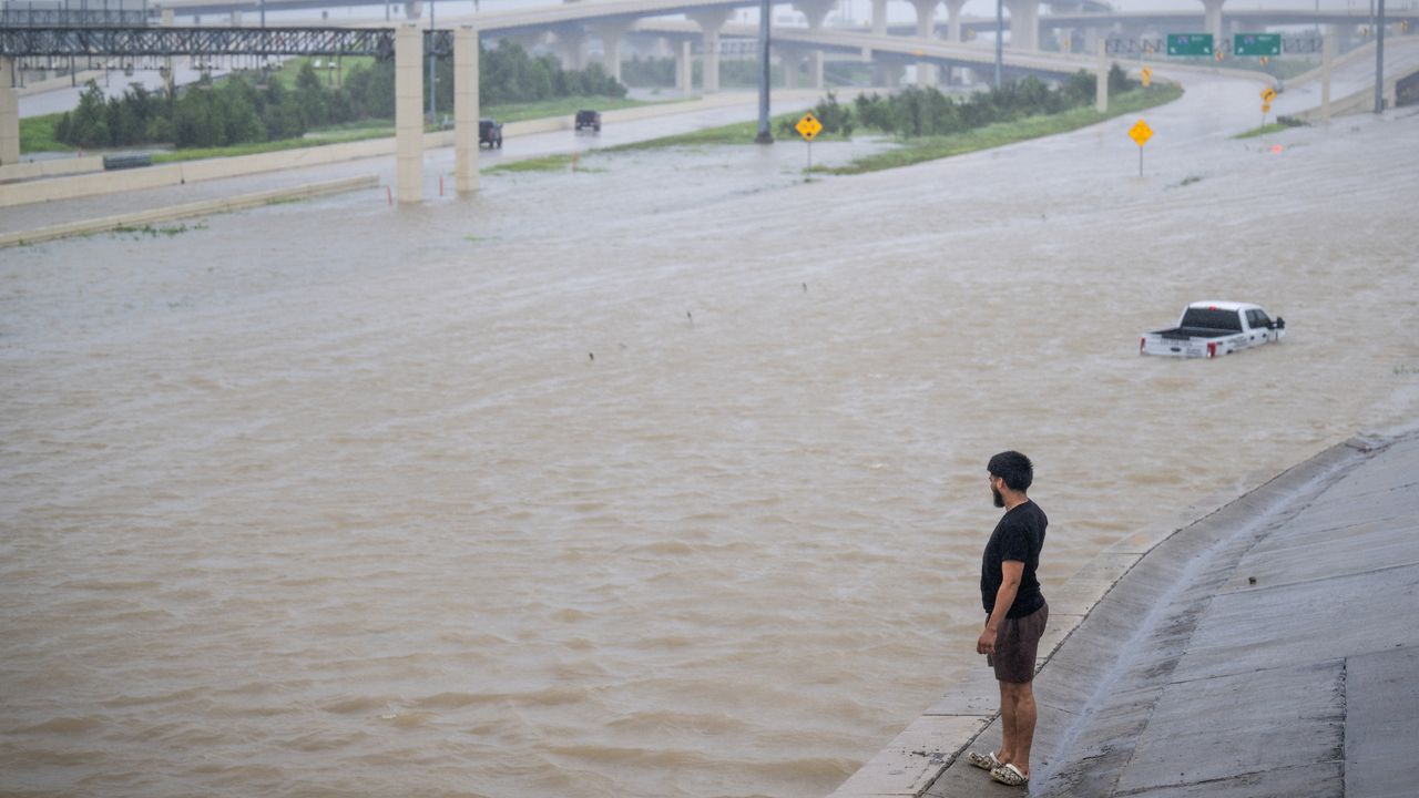 Man watches truck float away in Houston during Tropical Storm Beryl