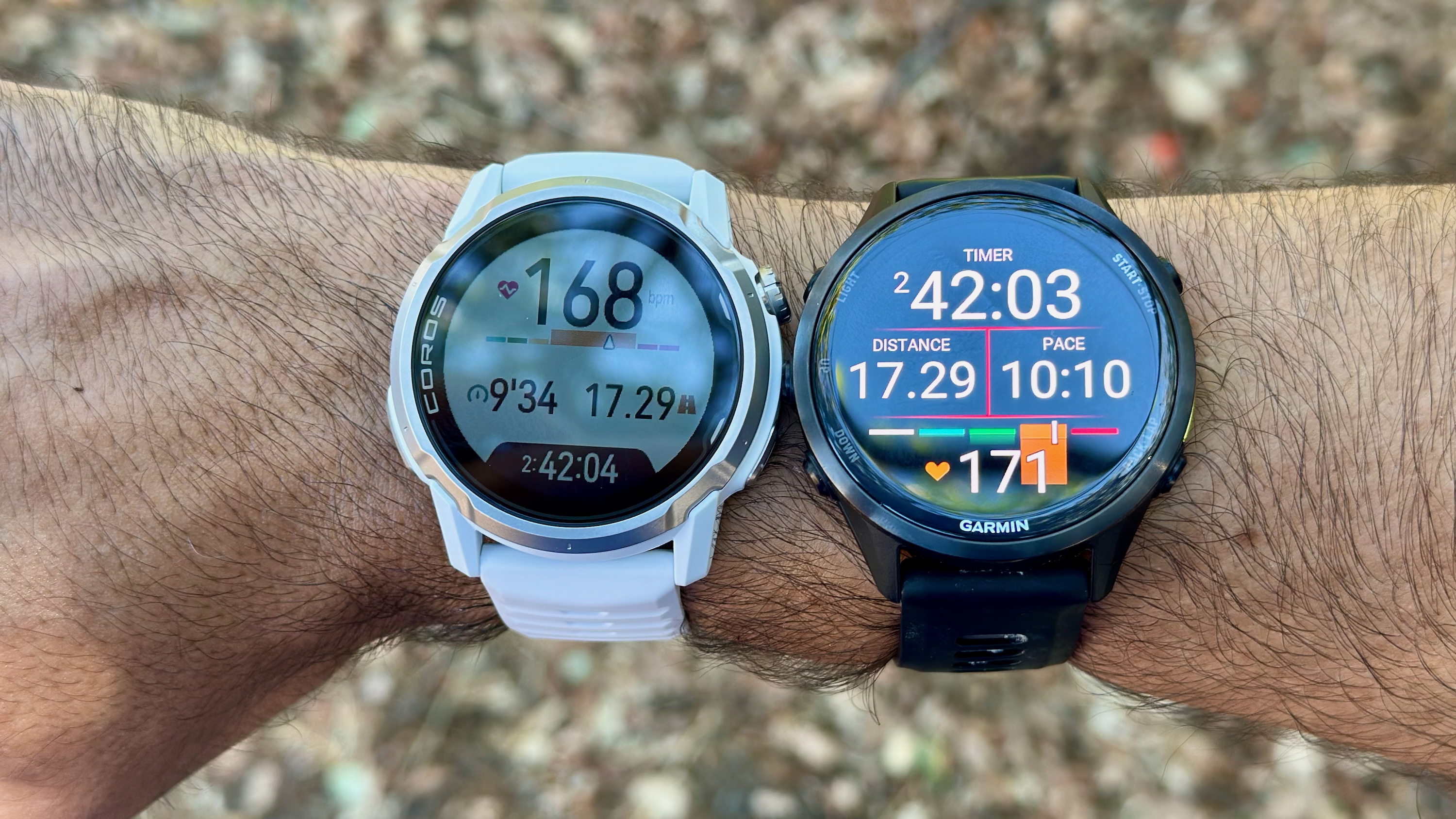 A photo of the COROS APEX 4 and Garmin Forerunner 970 on the same wrist, for comparing GPS and HR data in the same workout. COROS&#039;s distance data is the same but its HR is 3 bpm lower.