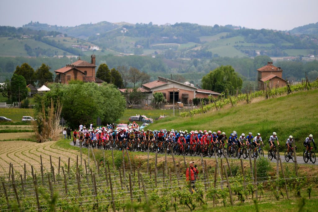 CANALE ITALY MAY 10 The peloton passing through Montegrosso dAsti vineyard landscape during the 104th Giro dItalia 2021 Stage 3 a 190km stage from Biella to Canale girodiitalia Giro on May 10 2021 in Canale Italy Photo by Tim de WaeleGetty Images