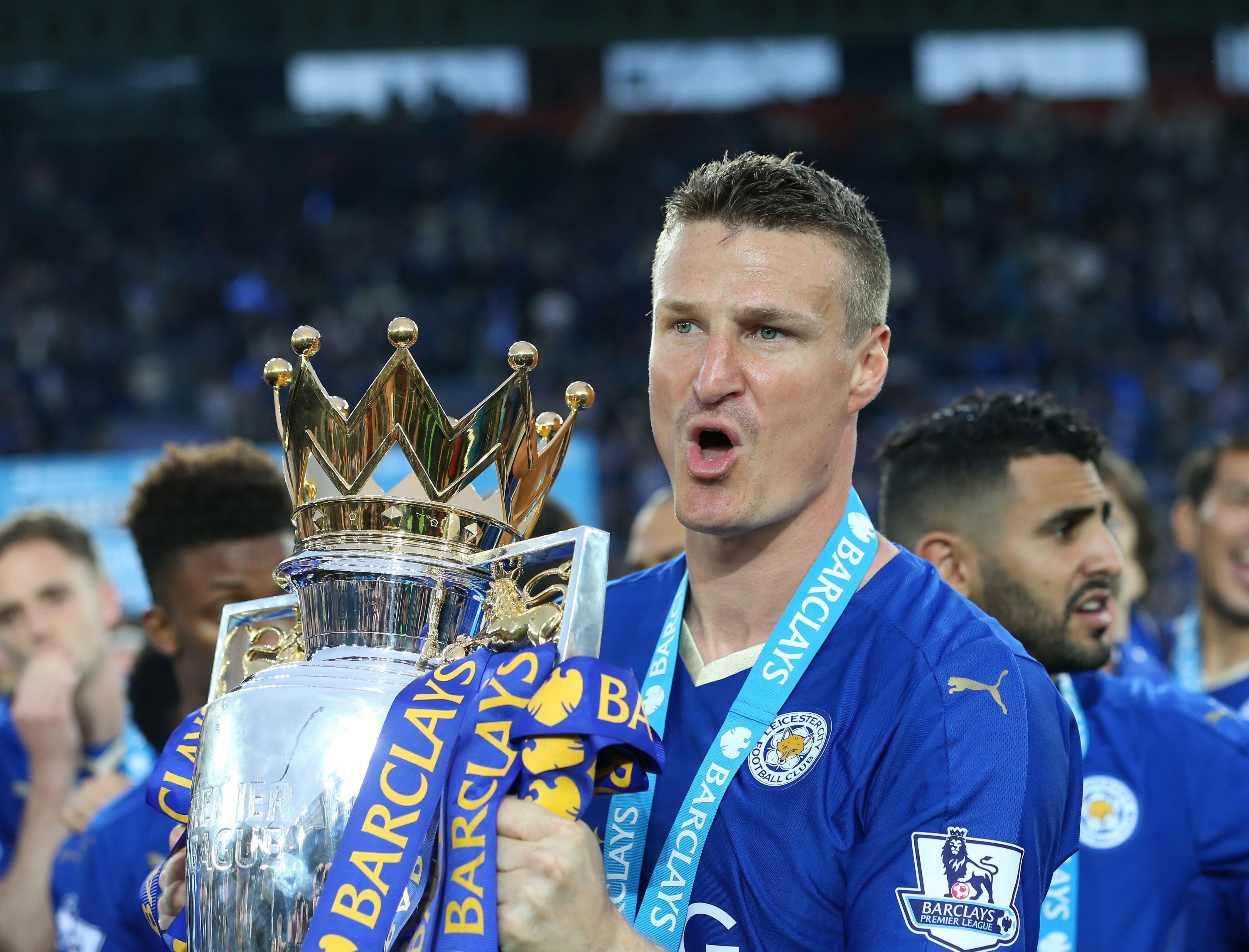 Leicester City's Robert Huth celebrates with the Premier League trophy, 2016