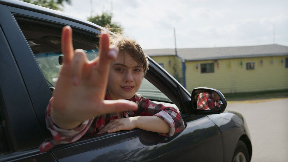 Emilia Jones signs I love you in CODA