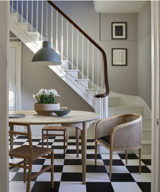 Monochrome dining scheme with checkerboard flooring and hallway lighting