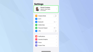 iOS Settings app with Apple ID info highlighted