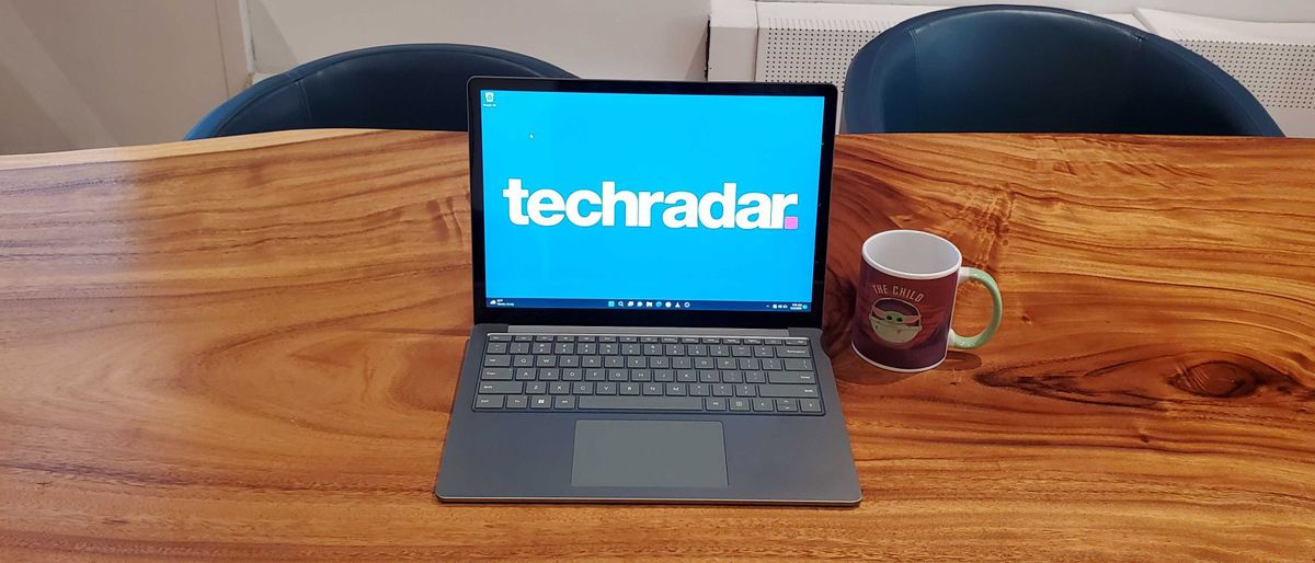 Microsoft Surface Laptop 5, in silver, on a wooden desk