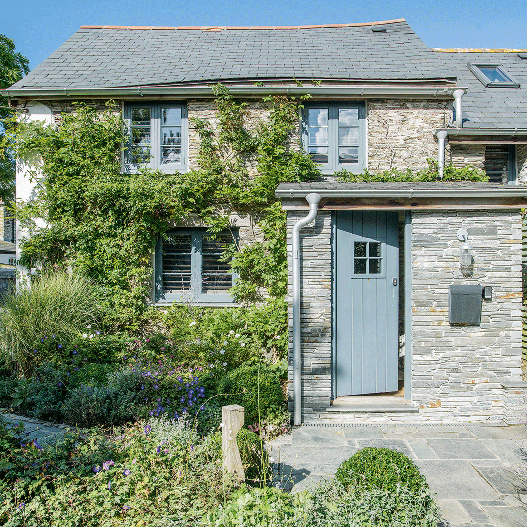 Blue front door and green garden