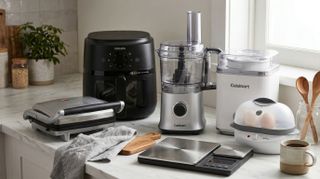 A collection of kitchen gadgets on a marble countertop