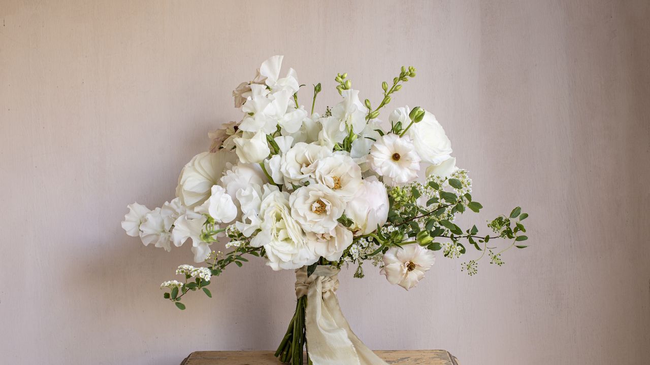 Bouquet of white flowers with spray roses, spirea, sweet peas and peonies