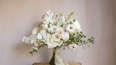 Bouquet of white flowers with spray roses, spirea, sweet peas and peonies