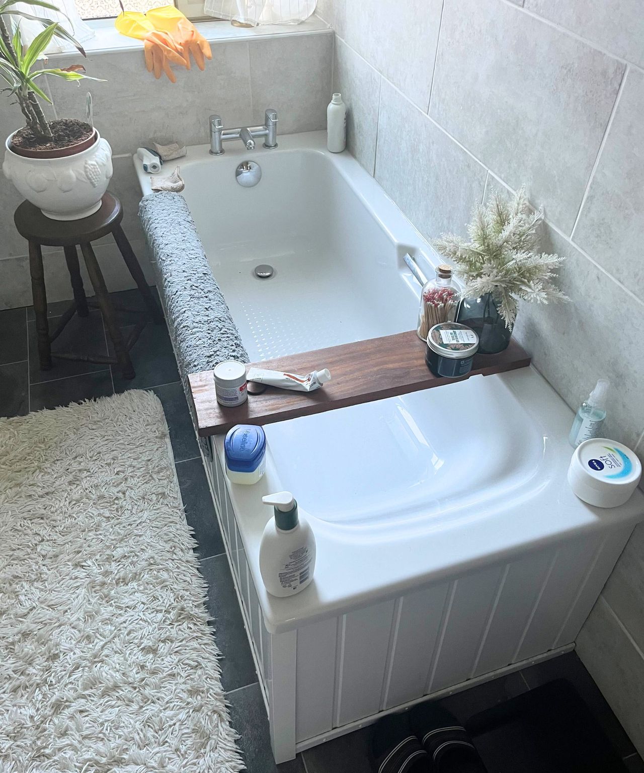 A white bathtub covered in product bottles.