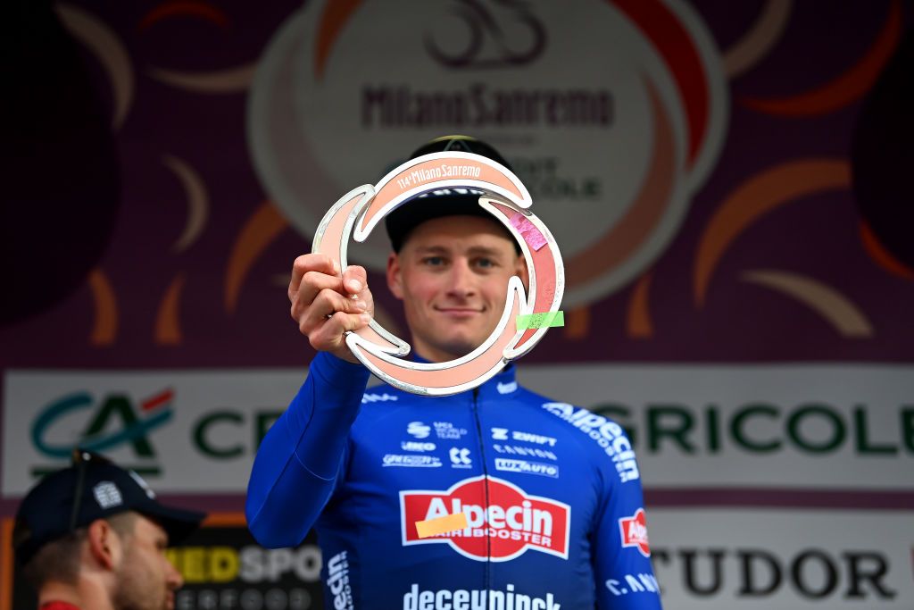 SANREMO ITALY MARCH 18 Mathieu Van Der Poel of The Netherlands and Team AlpecinDeceuninck celebrates at podium as race winner holding the trophy during the 114th MilanoSanremo 2023 a 294km one day race from Abbiategrasso to Sanremo MilanoSanremo UCIWT on March 18 2023 in Sanremo Italy Photo by Tim de WaeleGetty Images