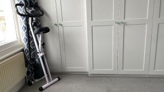 Marcy Foldable Exercise Bike folded and propped up in corner of a room