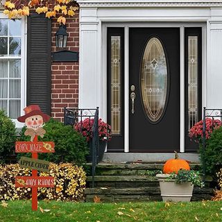 Front door with fall decor sign, pumpkin and flowers
