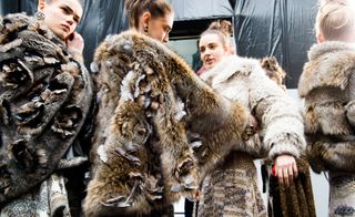 Chanel: Models wear oversized brown fur jackets