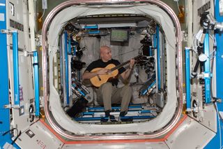 Italian astronaut Luca Parmitano of the European Space Agency plays guitar in weightlessness during his Expedition 37 mission on the International Space Station.