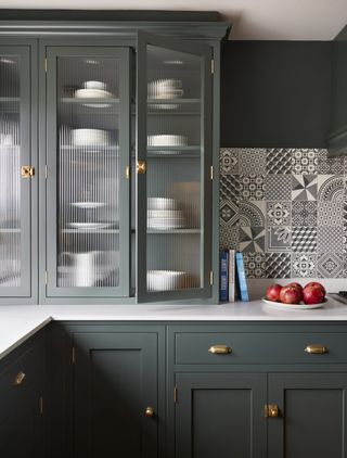 close up shot of dark green glass fronted cabinets