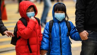Children wear surgical masks as protection against the coronavirus as Hong Kong marked the Lunar New Year on Jan. 27, 2020. 