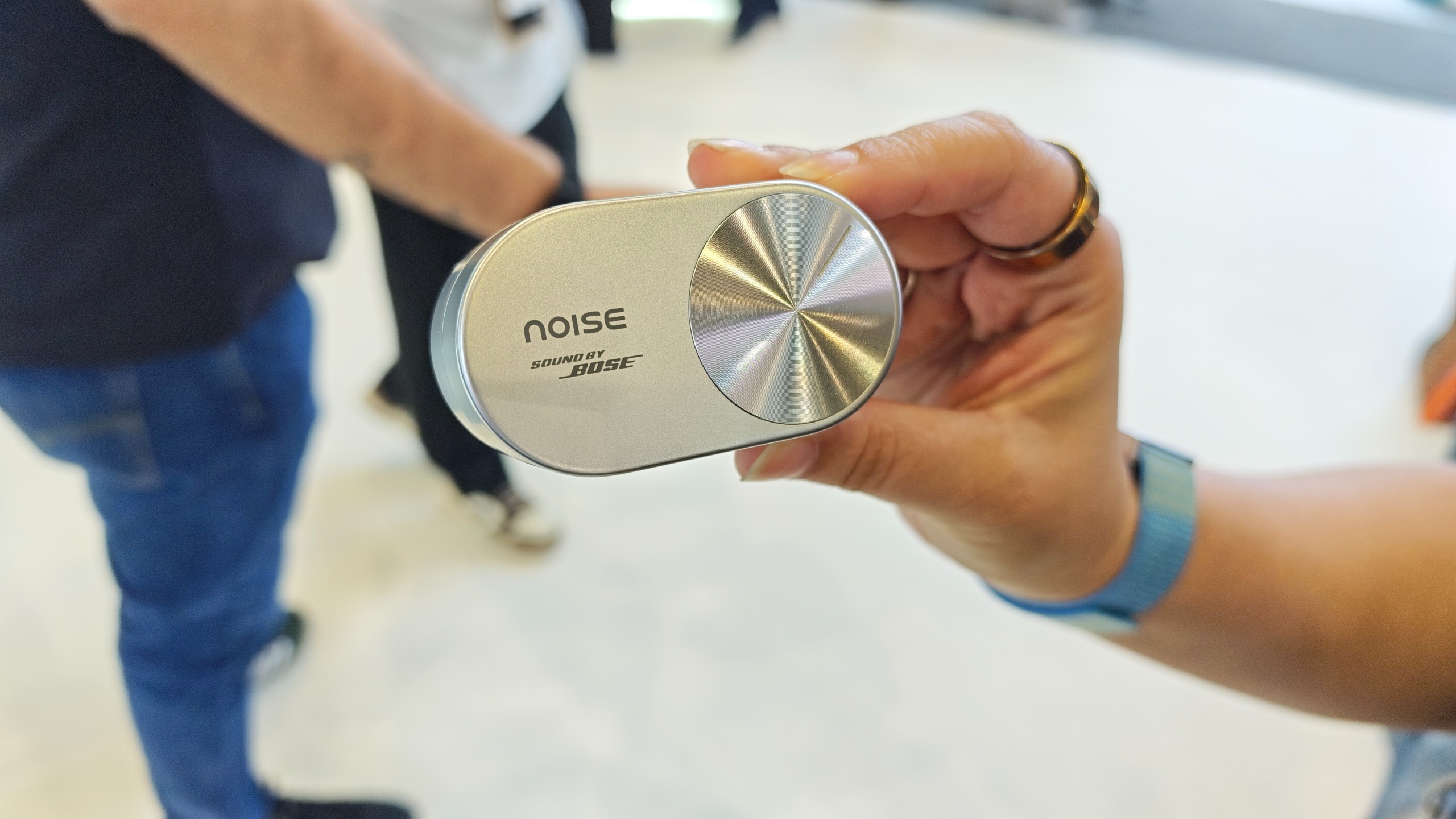 Woman holding the Noise Master Buds Open case