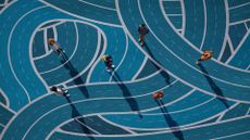 An illustration showing employees from above, walking on intersecting blue roads to represent workflow friction.