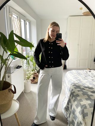 Florrie wears a textured knit jacket and white wide jeans from H&M