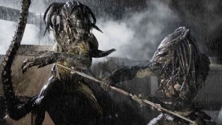 Still from the movie Alien vs. Predator: Requiem (AvPR). Predator is jabbing a spear at a swiping Alien during a heavy rainstorm.