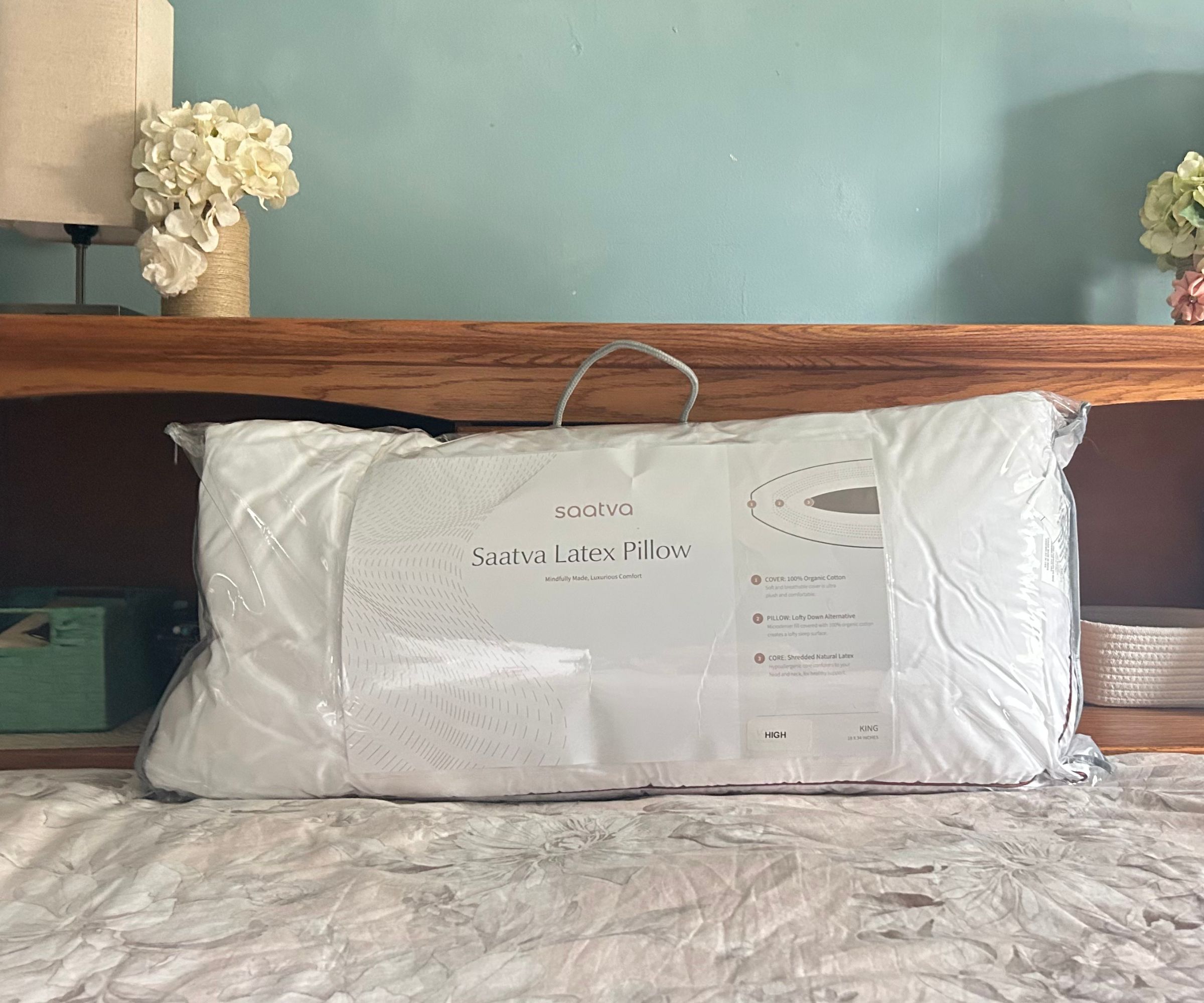 Saatva latex pillow in a bag on a bed