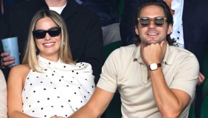 Margot Robbie in the stands at Wimbledon wearing the black and white polka dot dress trend in the form of an Alaïa dress