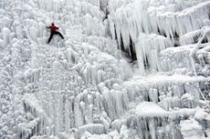 A man climbs up an artificial ice wall in Liberec, Czech Republic.