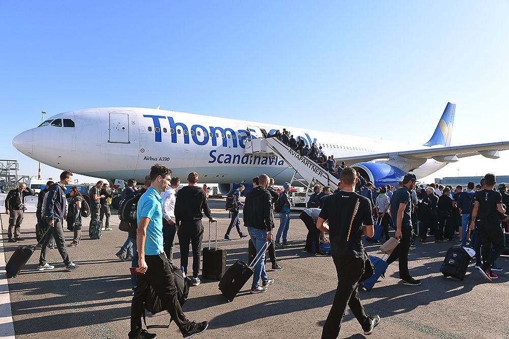 Riders make their way toward the charter plane that will take them to Italy.