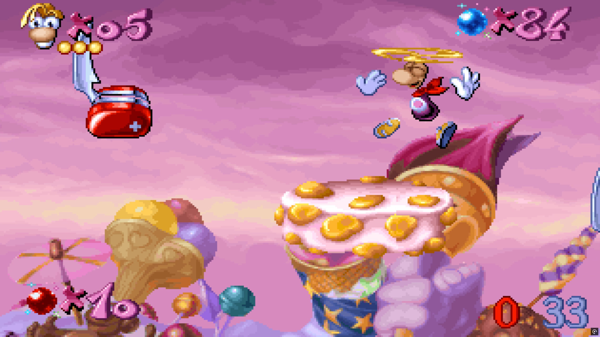 Rayman glides towards a cake ledge in a food level in Rayman 30th Anniversary Edition's Rayman Designer level pack