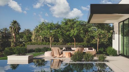 The exterior of a California desert house featuring a pool terrace and serene plant surroundings