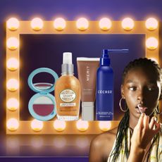 four beauty products surrounded by a lit up makeup mirror and a model getting lipstick applied