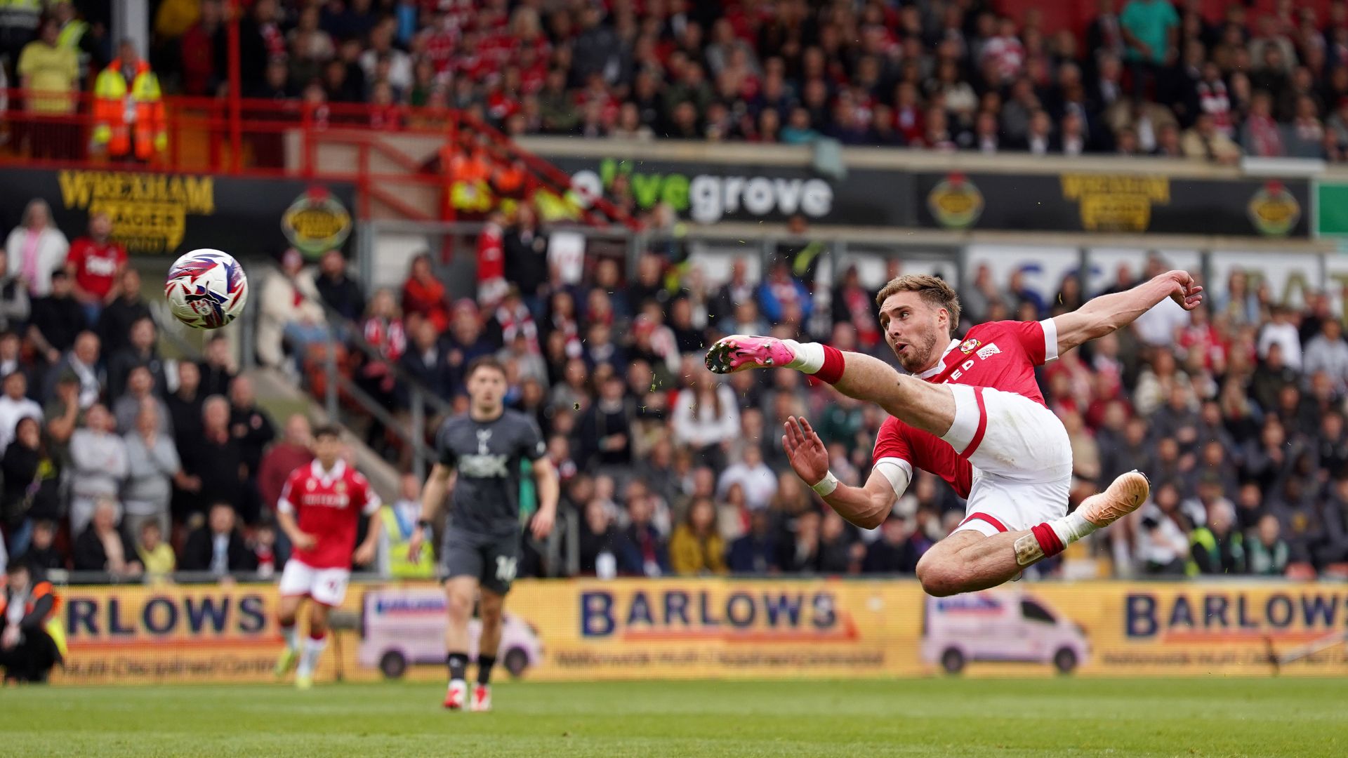 an image of Sam Smith of Wrexham scoring his team's second goal during the Sky Bet League One match between Wrexham AFC and Charlton Athletic FC at Racecourse Ground on April 26, 2025 in Wrexham, Wales
