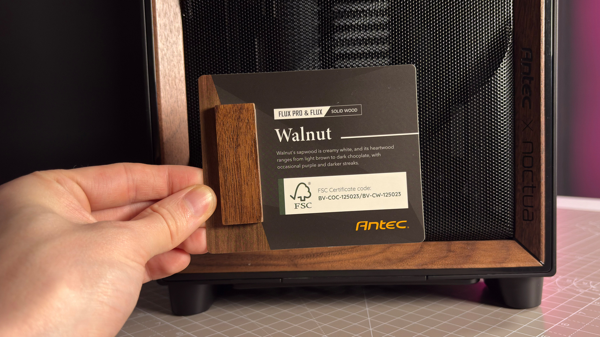 The Antec Flux Pro Noctua Edition on a desk with various parts disassembled.