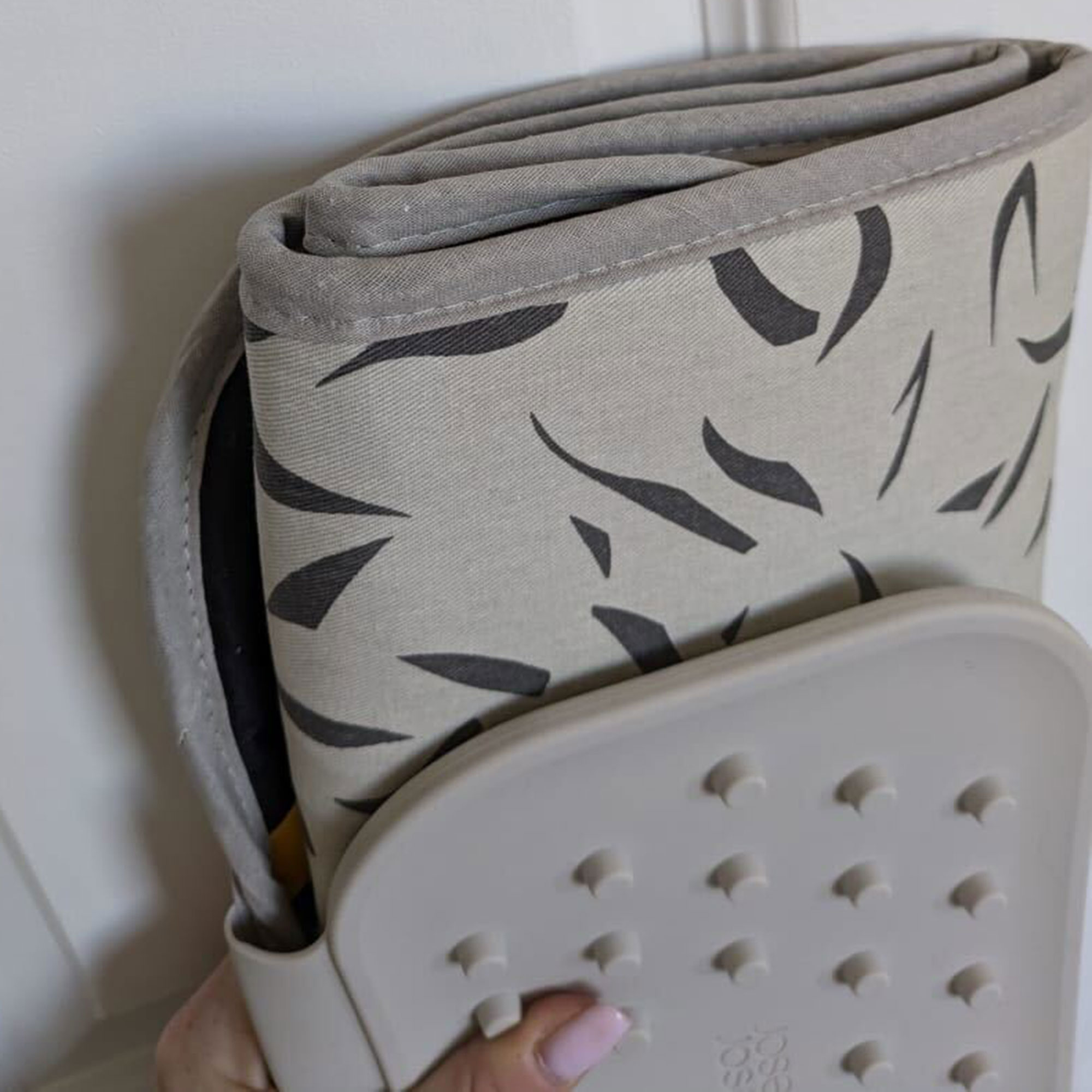 Grey patterned ironing mat folded up