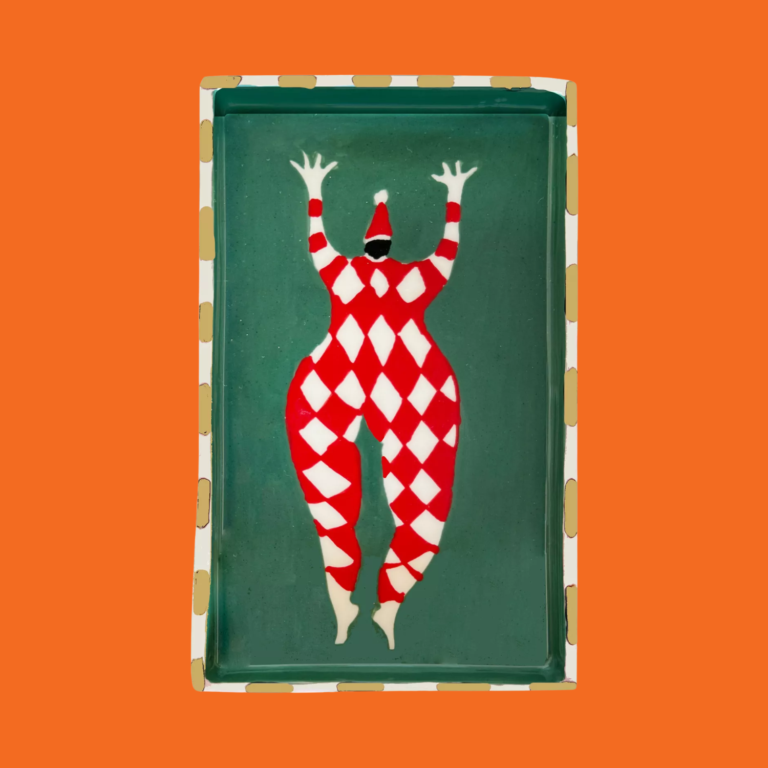 A colorful tray with a harlequin-style santa drawing