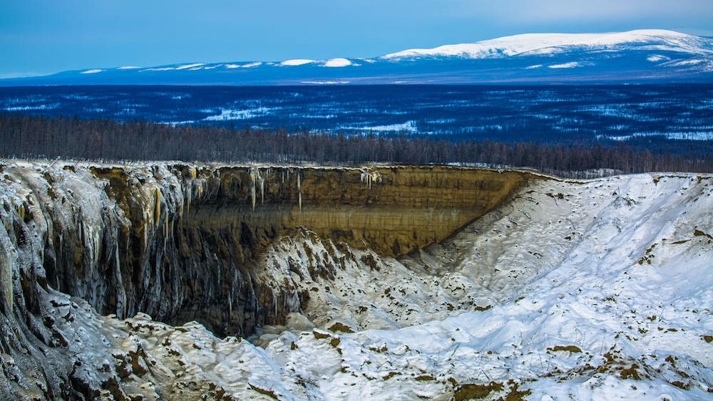 A giant crater in Siberia covered in snow and ice. 