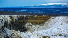 A giant crater in Siberia covered in snow and ice. 
