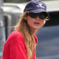 Jennifer Lawrence styled her strawberry red polo top with peony pink pants, making spring's ultimate color combination